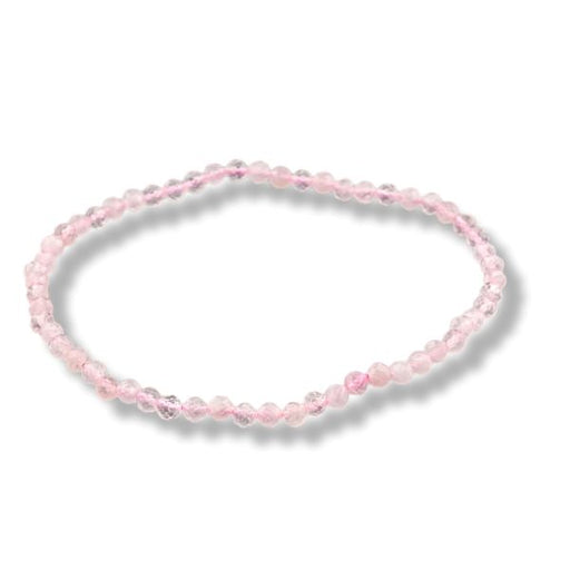 A delicate beaded stretch bracelet made of small, faceted light pink beads, arranged in a circle on a white background with a soft drop shadow.