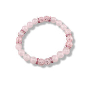 A pink beaded stretch bracelet featuring light pink round beads, faceted pink crystal beads, and silver-toned spacers, shown on a clean white background.
