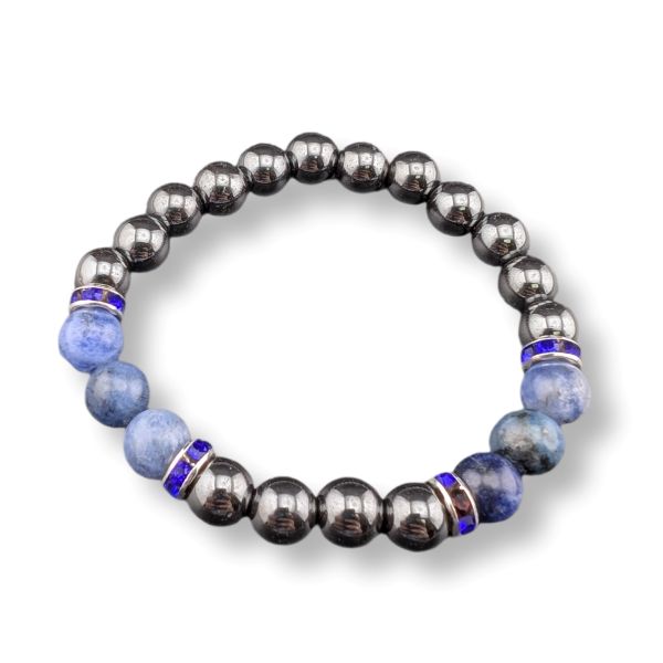 A beaded stretch bracelet featuring metallic dark gray gunmetal beads, light blue sodalite beads, and small blue and silver spacer rings, shown on a white background.