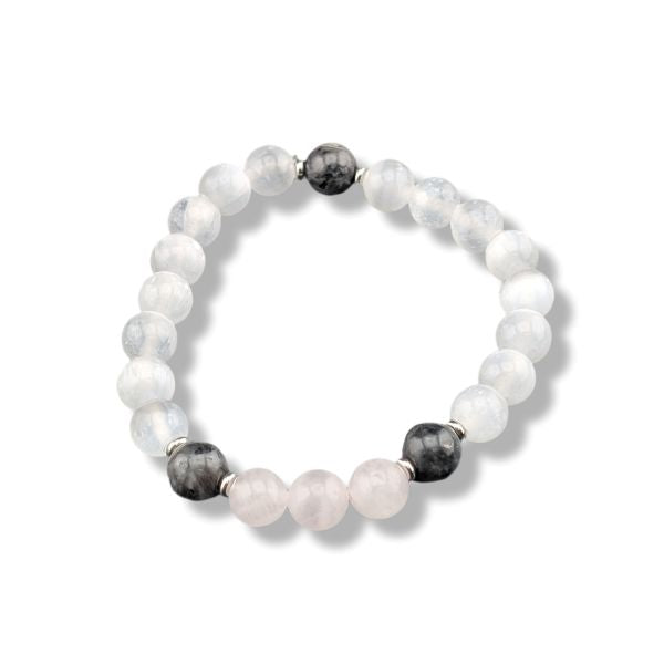 A beaded stretch bracelet featuring white and pale pink stone beads, accented by two dark gray beads and small silver spacer rings, shown on a white background.
