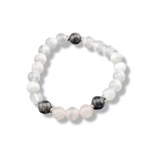 A beaded stretch bracelet featuring white and pale pink stone beads, accented by two dark gray beads and small silver spacer rings, shown on a white background.