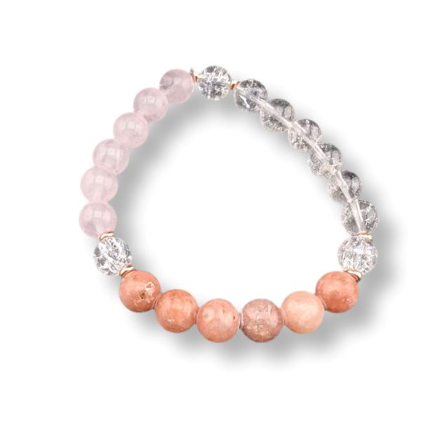 A beaded stretch bracelet featuring light pink rose quartz beads, peachy-orange quartz beads, and clear faceted crystal spacer beads, displayed on a clean white background.