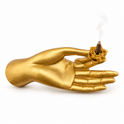 A golden coloured Mudra Hand  incense burner on a white background.