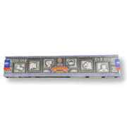 Box of incense sticks with decorative design on a white background