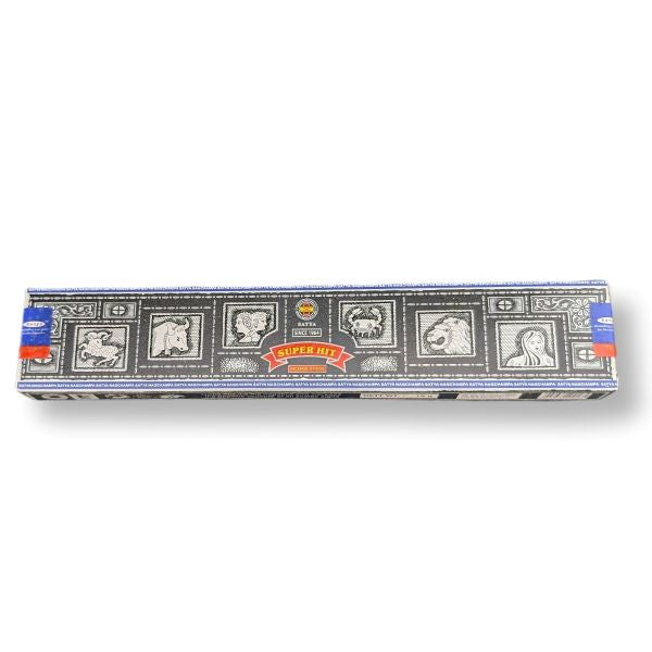 Box of incense sticks with decorative design on a white background