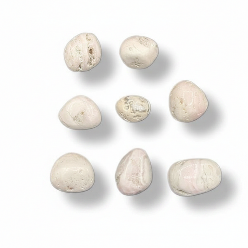 Nine smooth, polished river stones in soft cream, beige, and pale pink hues, arranged in a 3x3 grid on a clean white background with soft drop shadows.
