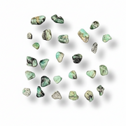 Scattered green stones on a white background