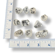 Tumbled quartz crystal  on a white background with a ruler for scale