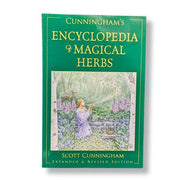 Book titled 'Cunningham's Encyclopedia of Magical Herbs' on a white background