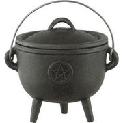 Black cast iron cauldron with a pentagram symbol on a white background