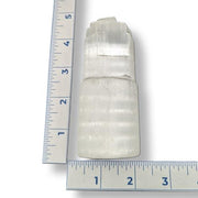 selenite tower with a ruler for scale on a white background