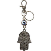 Keychain with Hamsa hand and eye charm on a white background