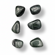 Six polished dark green tumbled stones arranged in a loose vertical column on a white background with soft drop shadows.