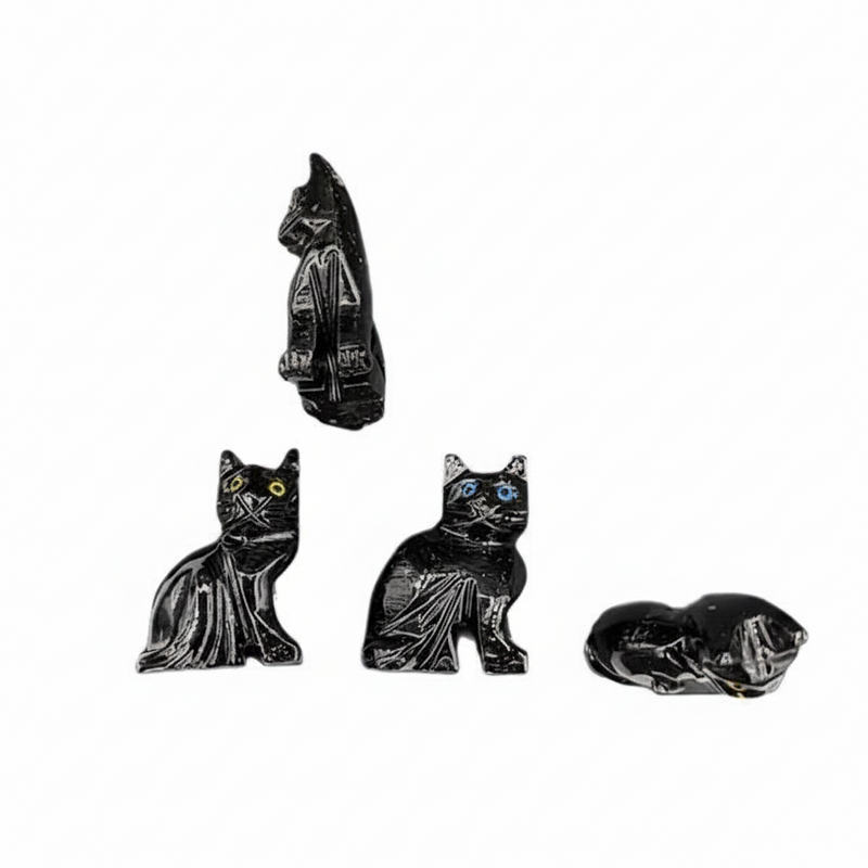 Set of four black cat figurines on a white background