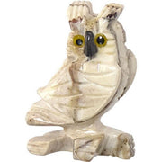Small owl figurine on a branch with a white background