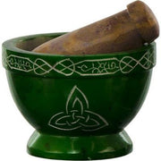 Green mortar and pestle with Celtic knot design on a white background