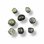 Greenish-brown stones on a white surface