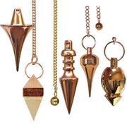 Collection of copper  pendulums on a white background