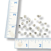 Herkimer Diamonds on a white background with a ruler for scale