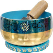 Tibetan singing bowl with decorative patterns and a wooden striker on a white background