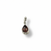 Silver pendant with a teardrop-shaped brown gemstone on a white background