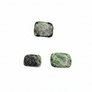 Four green and black stone earrings on a white background