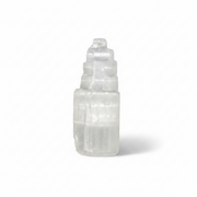 A selenite tower photographed on a clean white background with a soft shadow.