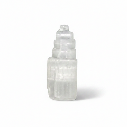 A selenite tower photographed on a clean white background with a soft shadow.