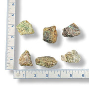 Mineral samples with a ruler for scale on a white background