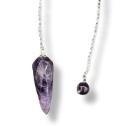 Pendulum with a purple crystal pendant on a white background