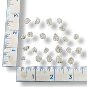 Baby apophyllite points  on a white background with a ruler for scale