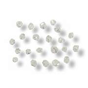 A set of small, rough-cut clear gemstones arranged in a loose circle on a white background with soft drop shadows.