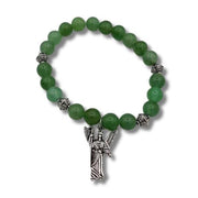 Green beaded bracelet with an angel charm on a white background