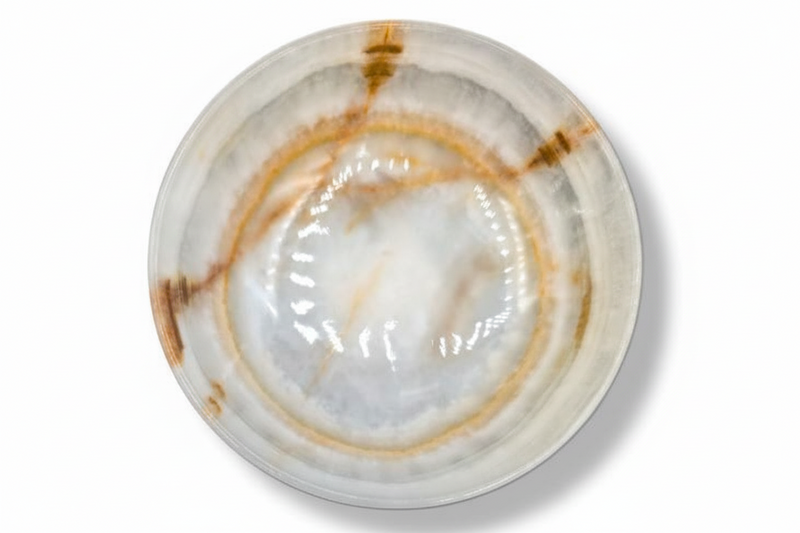 A round onyx bowl with a glossy finish, featuring a marbled pattern of white, beige, and brown concentric rings, photographed from a top-down perspective on a white background.