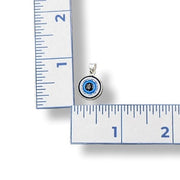 Pendant with blue and black design on a ruler for scale