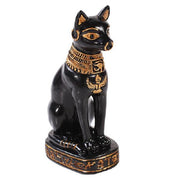 Black cat figurine with gold accents on a white background