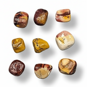 Mookaite polished gemstones on a white background .