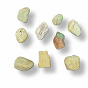Nine smooth, polished river stones in various shapes and colors, including shades of green, beige, yellow, and brown, arranged on a white background with soft drop shadows.
