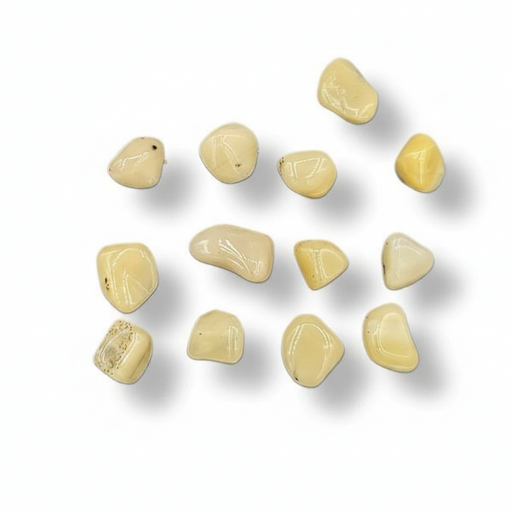 A series of tumbled yellow opal stones of varying sizes, displayed in front of a blue measuring tape for scale.