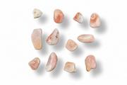 Ten polished tumbled stones in soft peach, pink, cream, and light beige tones, arranged on a clean white background with subtle drop shadows.
