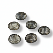 Labradorite palm stones on a white background