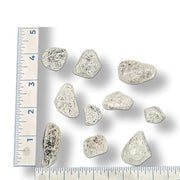 Fire and ice tumbled stones on a white background with rulers for size
