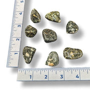 Mineral samples with a ruler for scale on a white background