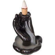 Black hand-shaped incense burner with a lit candle on a white background