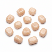 Ten smooth, polished peach-colored gemstone teardrop charms arranged in a loose circle on a clean white background.