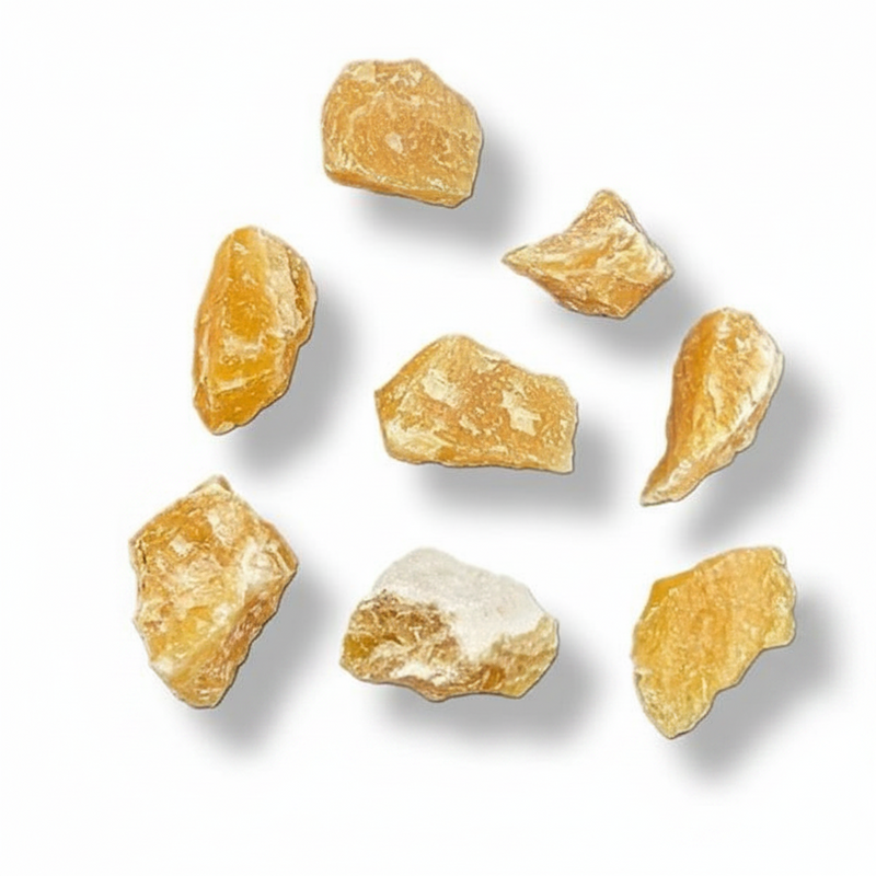 Seven raw, orange calcite crystals scattered on a clean white background with soft drop shadows.