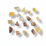 A set of 15 raw, rough-cut mineral or gemstone chips in various colors and shapes, arranged on a clean white background with soft drop shadows.