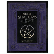 Book titled 'Book of Shadows & Light' with a pentagram symbol on a black background