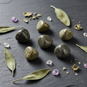 Mineral stones and crystals on a dark surface with leaves