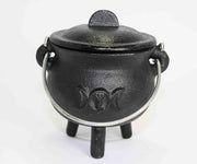 Black cast iron cauldron with lid on a white background